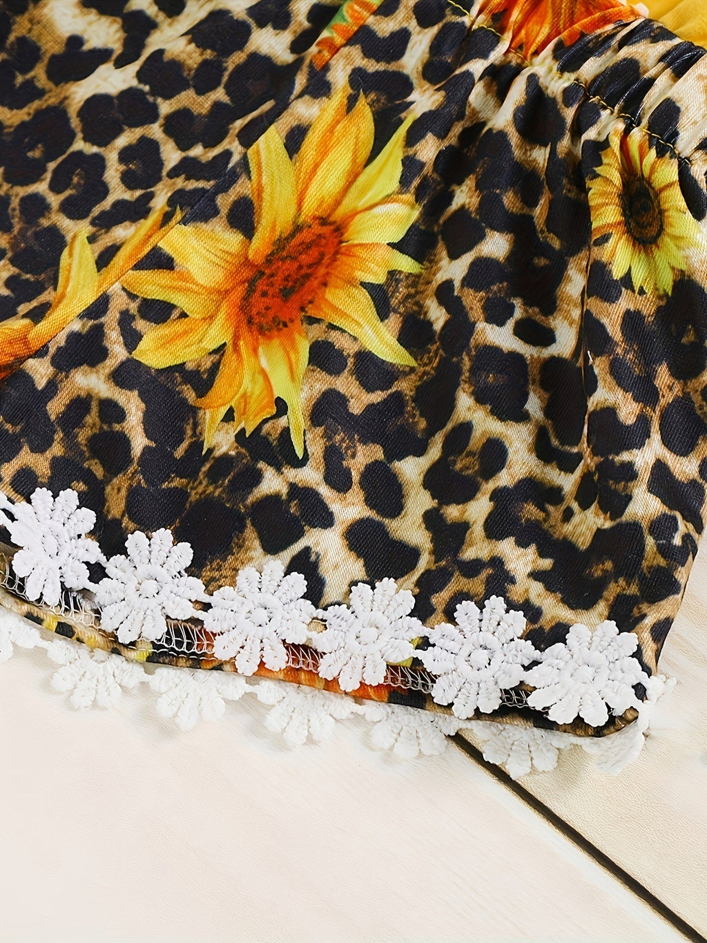 Baby Girl Sunflower and Leopard Print Romper with a Yellow Strappy Bodice and White Flower Trim