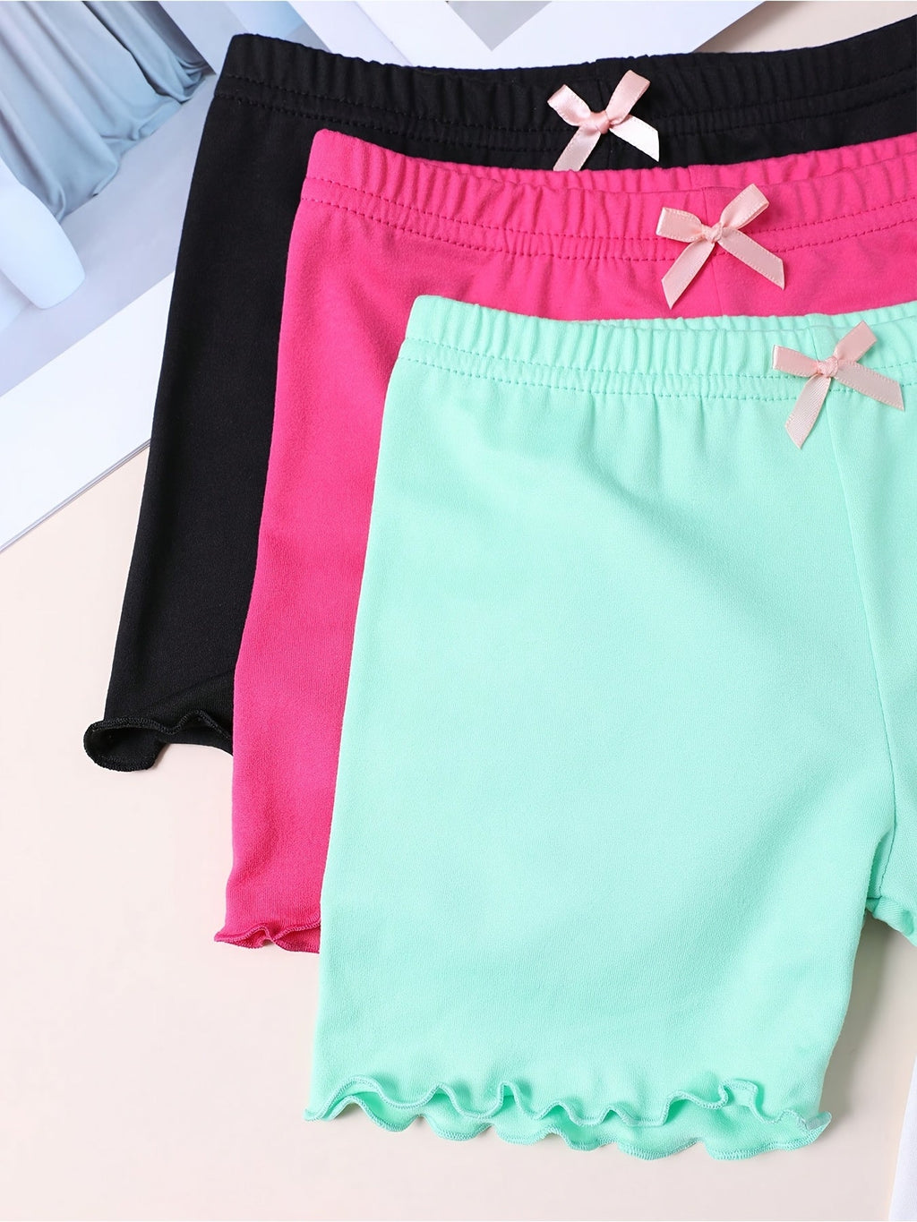 Girls' Layering Shorts Four-Pack with Small Waist Bows and Lettuce Hems for Everyday Dresses and Skirts